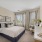 carpeted bedroom with large windows
