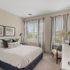 carpeted bedroom with large windows